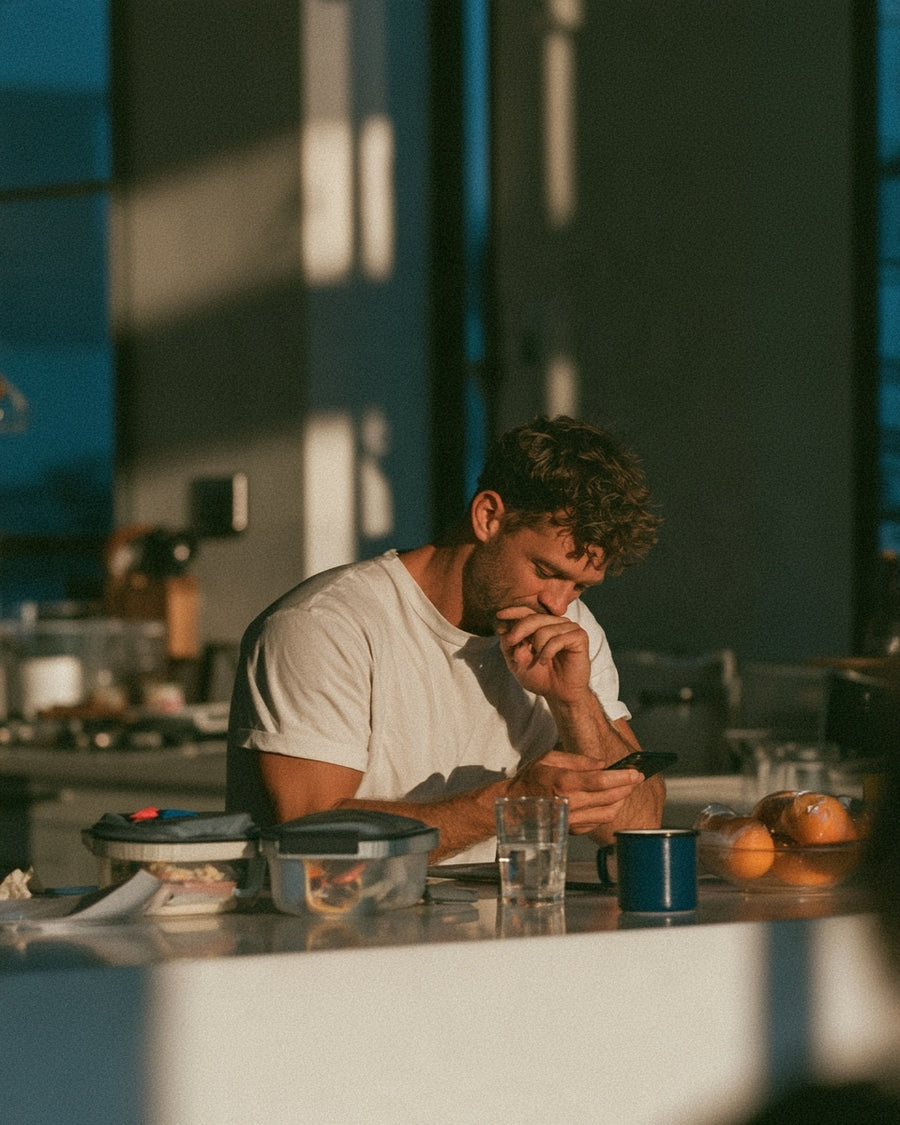 Person working at a table in a sunlit room.